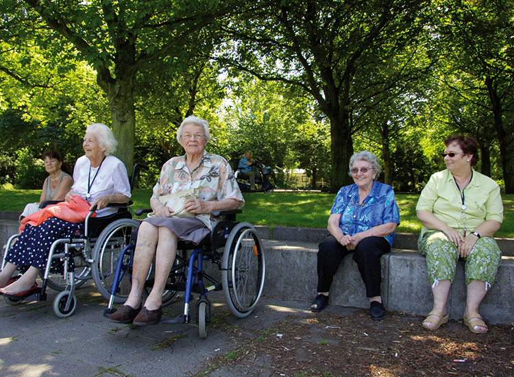 Dames in en rond een rolstoel