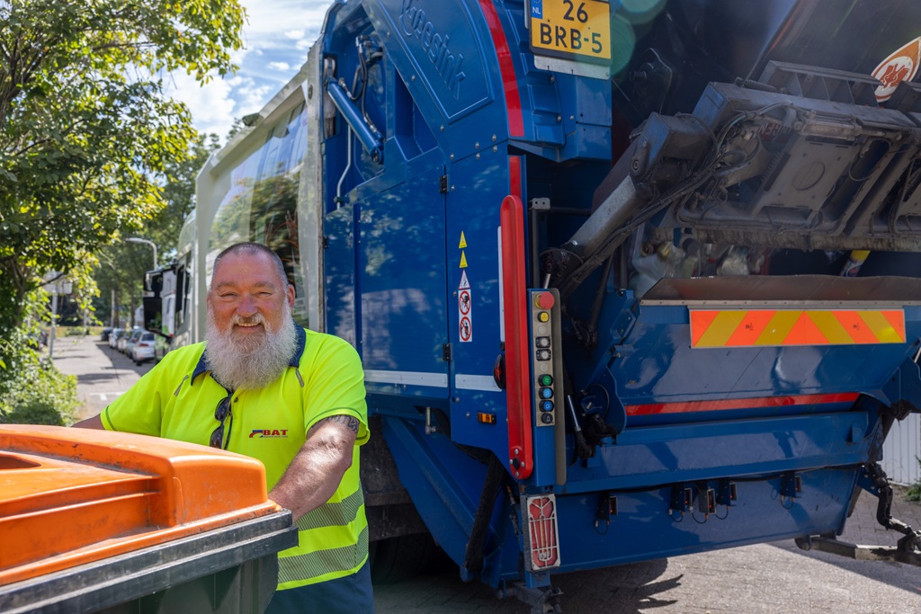 Bebaarde BAT medewerker met container voor wagen